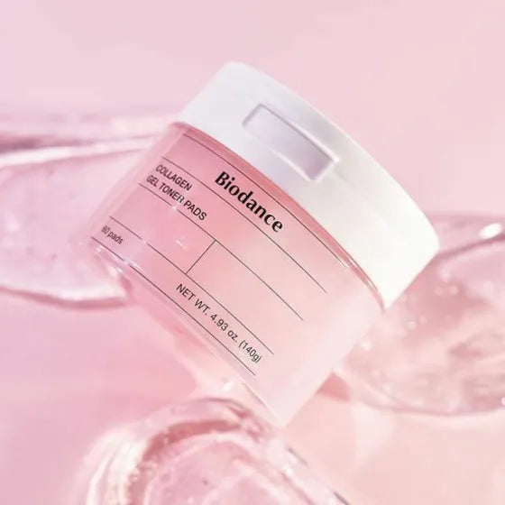 Soft, essence-coated jelly fabric texture of Biodance Collagen Gel Toner Pads being lifted with tweezers from their jar at Atelier De Glow UK.