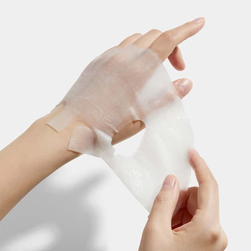 Plump, gelatinous, and ultra-adherent hydrogel-like sheet texture of Medicube Collagen Lifting Mask contouring perfectly to facial features at Atelier De Glow UK.