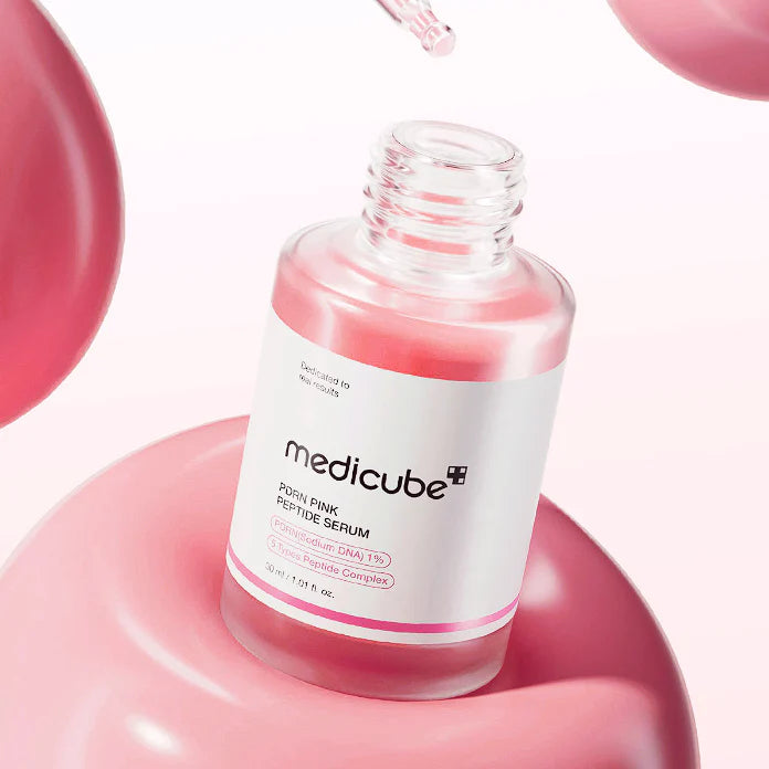 Silky, vibrant pastel pink fluid texture of Medicube Pink Peptide Serum absorbing weightlessly into the skin layers at Atelier De Glow UK.
