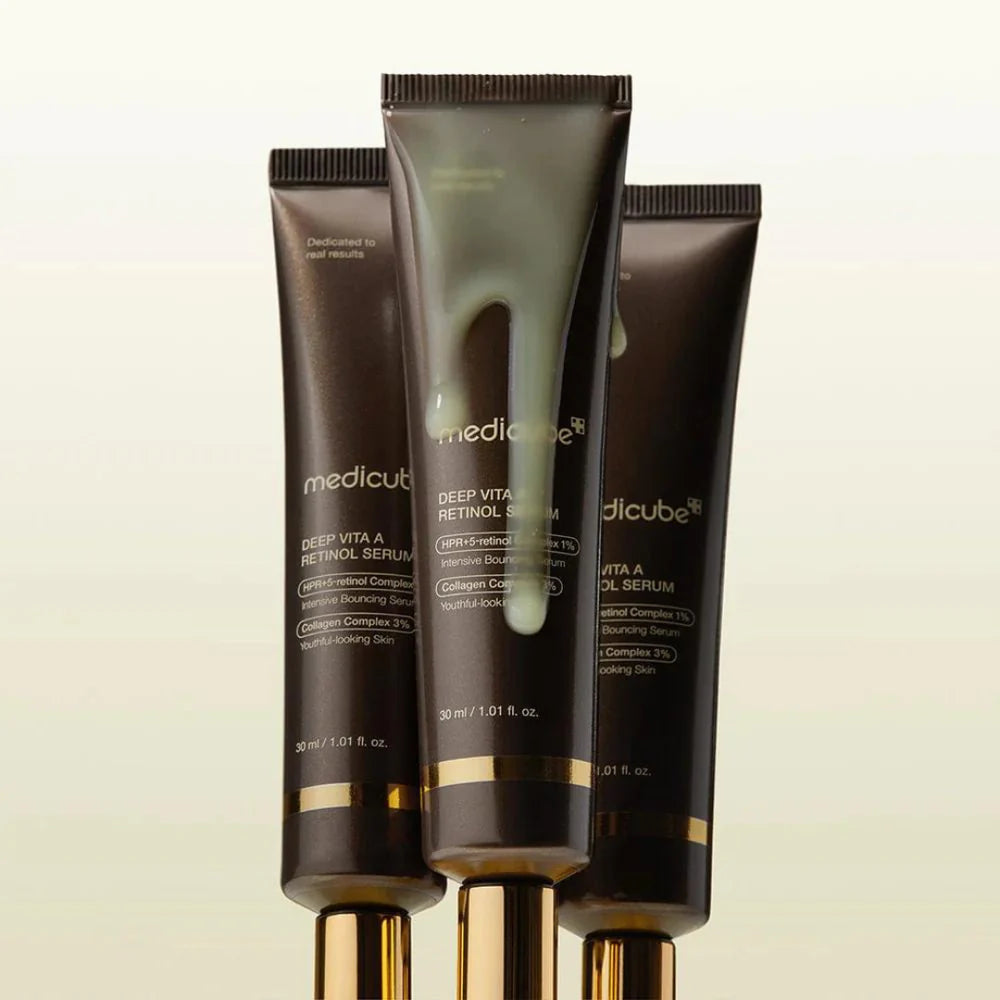 Rich, silky-smooth, and vibrant yellow fluid texture of Medicube Deep Vita A Retinol Serum dropping onto a texturized skin canvas at Atelier De Glow UK.