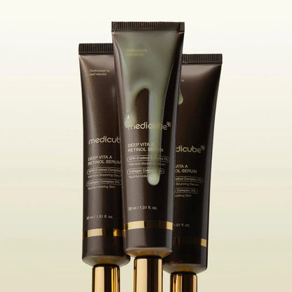 Rich, silky-smooth, and vibrant yellow fluid texture of Medicube Deep Vita A Retinol Serum dropping onto a texturized skin canvas at Atelier De Glow UK.