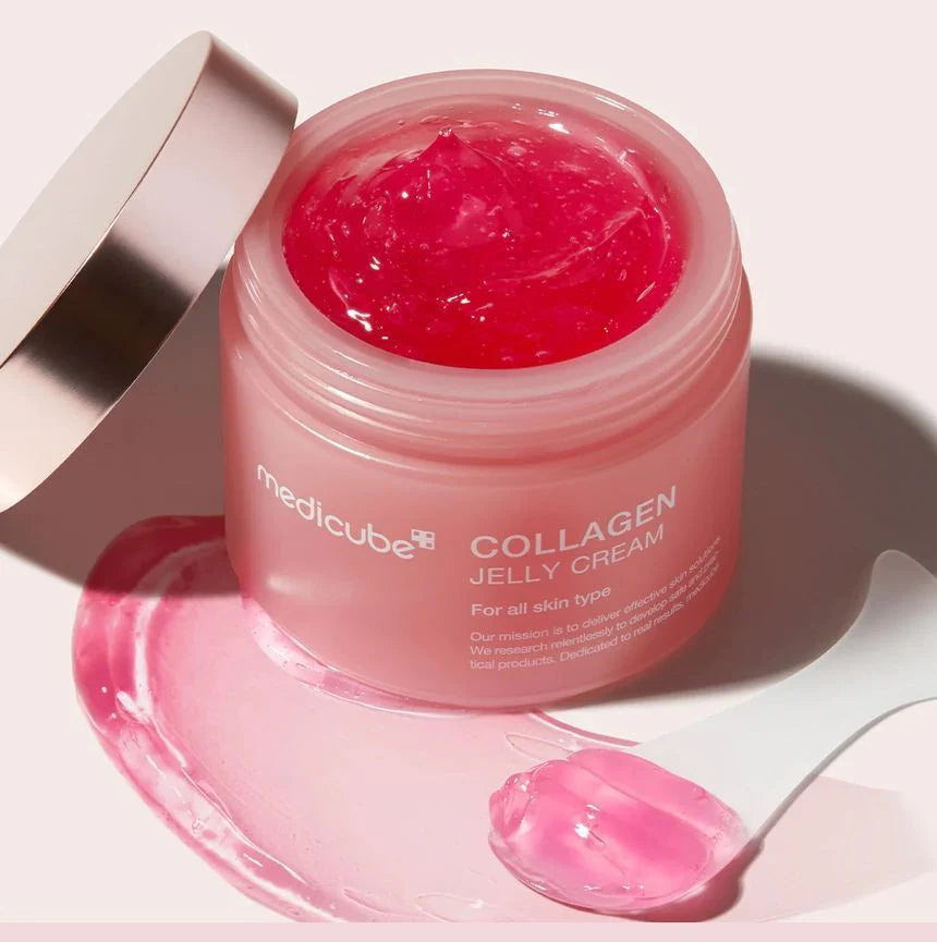 Bouncy, pink-tinted transparent gel-jelly texture of Medicube Collagen Niacinamide Cream melting smoothly into a dewy finish at Atelier De Glow UK.