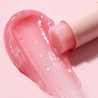 Solid, pastel pink, and ultra-smooth balm texture of Medicube PDRN Pink Collagen Volume Multi Balm gliding effortlessly onto a clear face at Atelier De Glow UK.