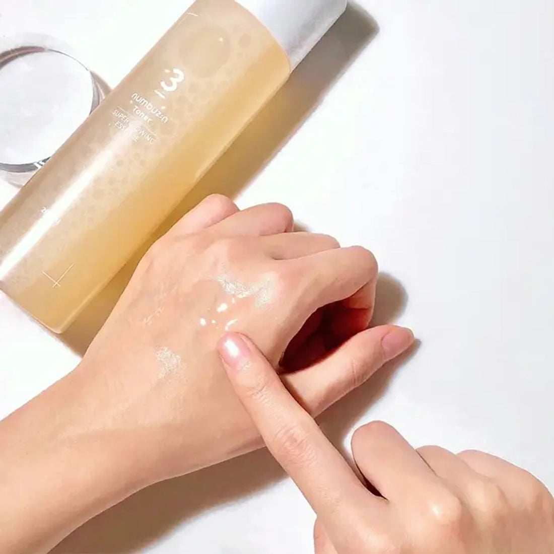 Numbuzin No.3 Super Glowing Essence Toner for revitalizing dull, rough, and dehydrated skin while boosting radiance and improving overall skin texture from Atelier De Glow UK.