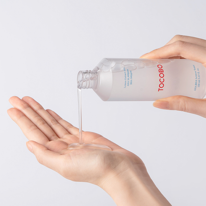 Water-light, ultra-refreshing, and fast-absorbing clear liquid texture of TOCOBO AHA BHA Toner sweeping across a dull skin canvas at Atelier De Glow UK.